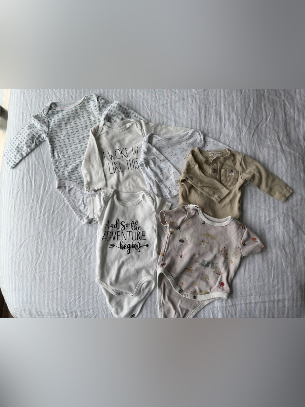 Assorted baby clothes and sleep sack